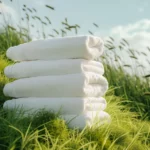 Étiquette du fondant parfumé 'Grand air frais' à la cire de soja. L'illustration montre une pile de serviettes blanches propres dans l'herbe, évoquant le parfum du linge séché au soleil.