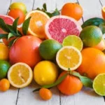 Étiquette du fondant parfumé 'Agrumes' à la cire de soja. L'illustration est une photo d'un assortiment d'agrumes (citron, orange, pamplemousse), évoquant un parfum frais, pétillant et énergisant.